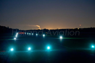 Landing strip, runway with airport lights from Holland Aviation at night.