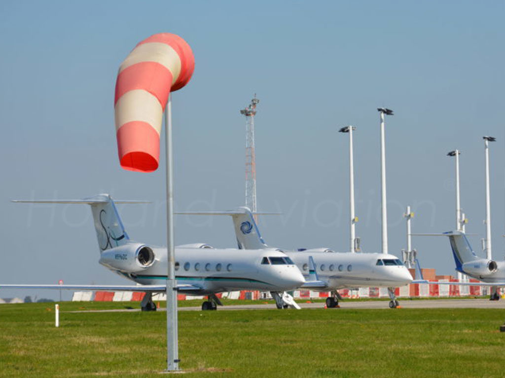 Windsock in the wind at the airport near the landing strip.