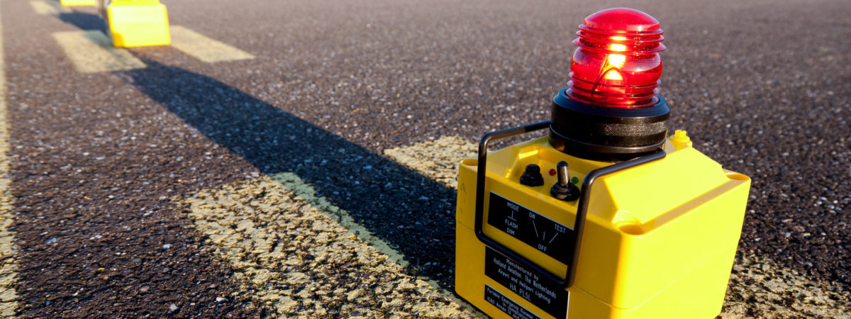 PL5 portable light civil on a runway with red light.